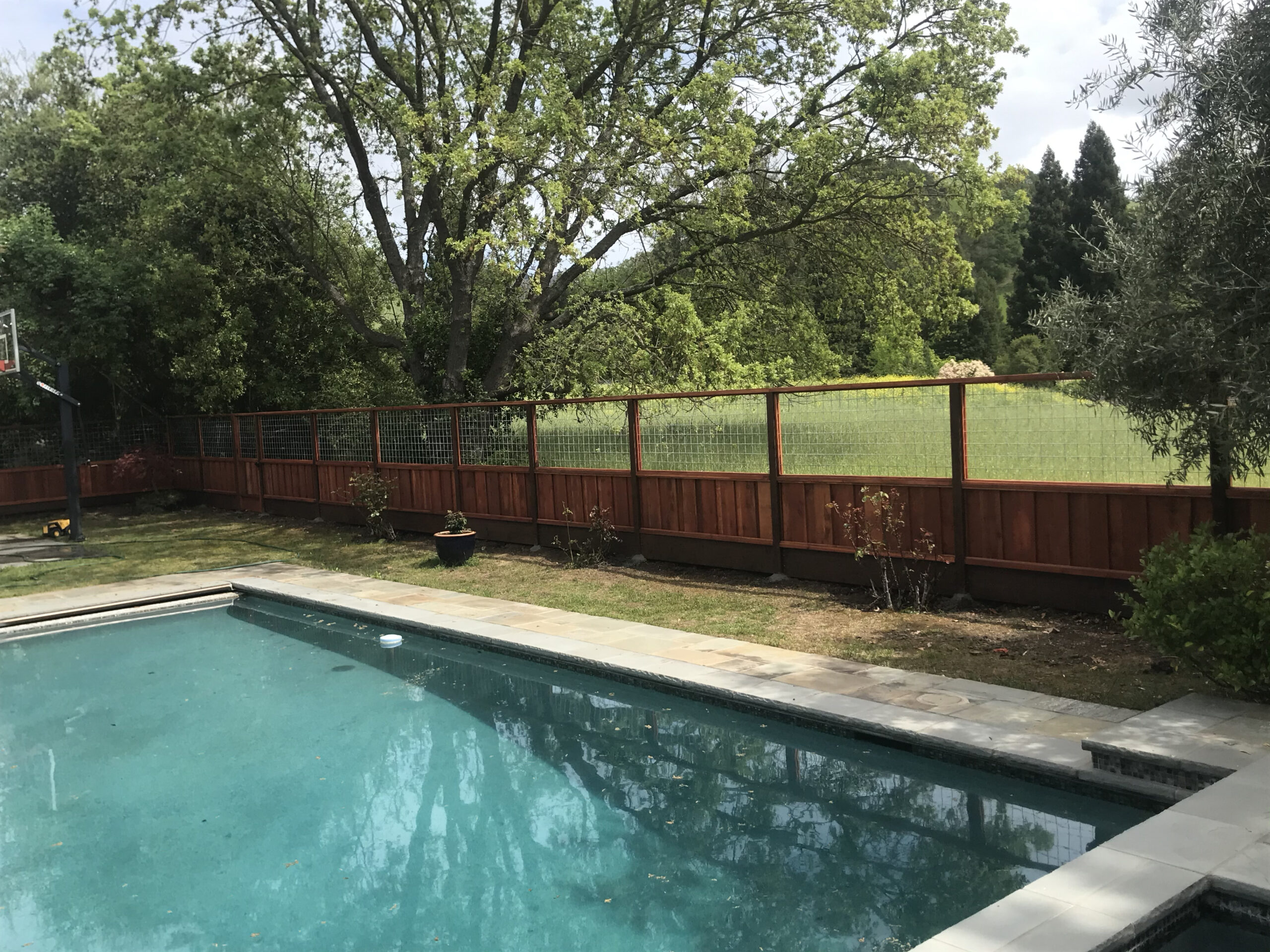 Picture of This custom installation features hogwire over a picture frame fence. - AMM Fencing