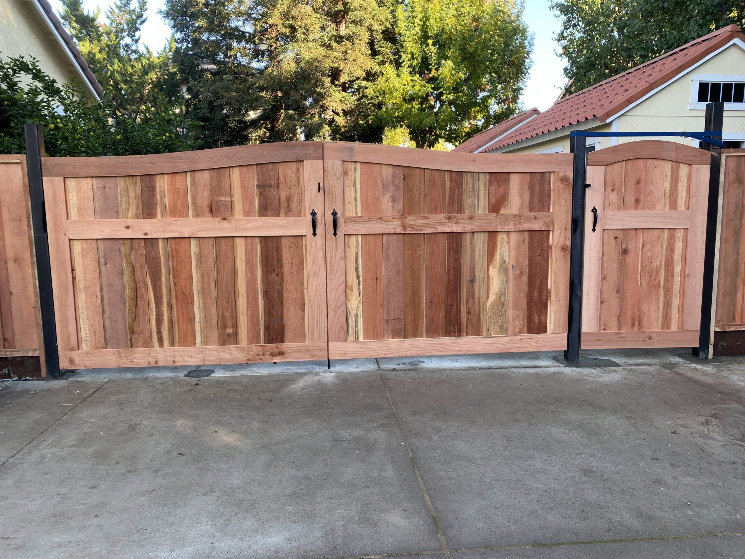 Picture of AMM Fencing installed this custom framed arch gate. - AMM Fencing