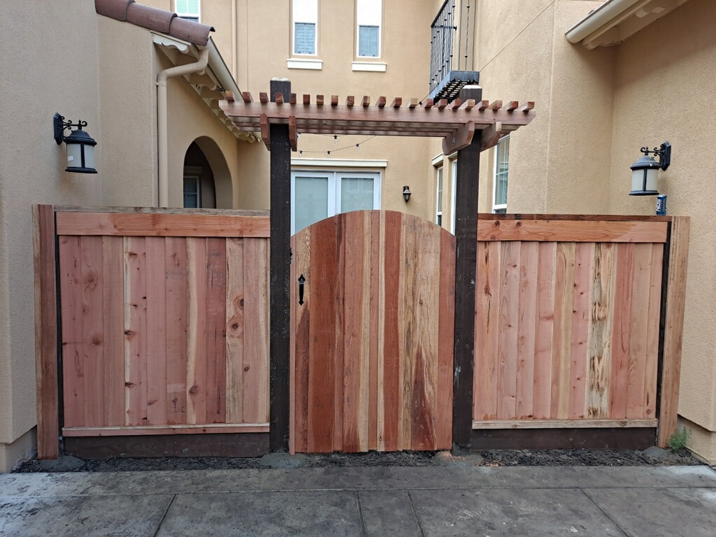 Picture of AMM Fencing used thick-cut overlapping boards to create this louvered redwood fence. - AMM Fencing