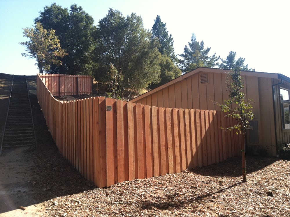 Picture of This “dog ear” redwood fence features a 1×1-inch trim that prevents gaps from shrinking boards. - AMM Fencing