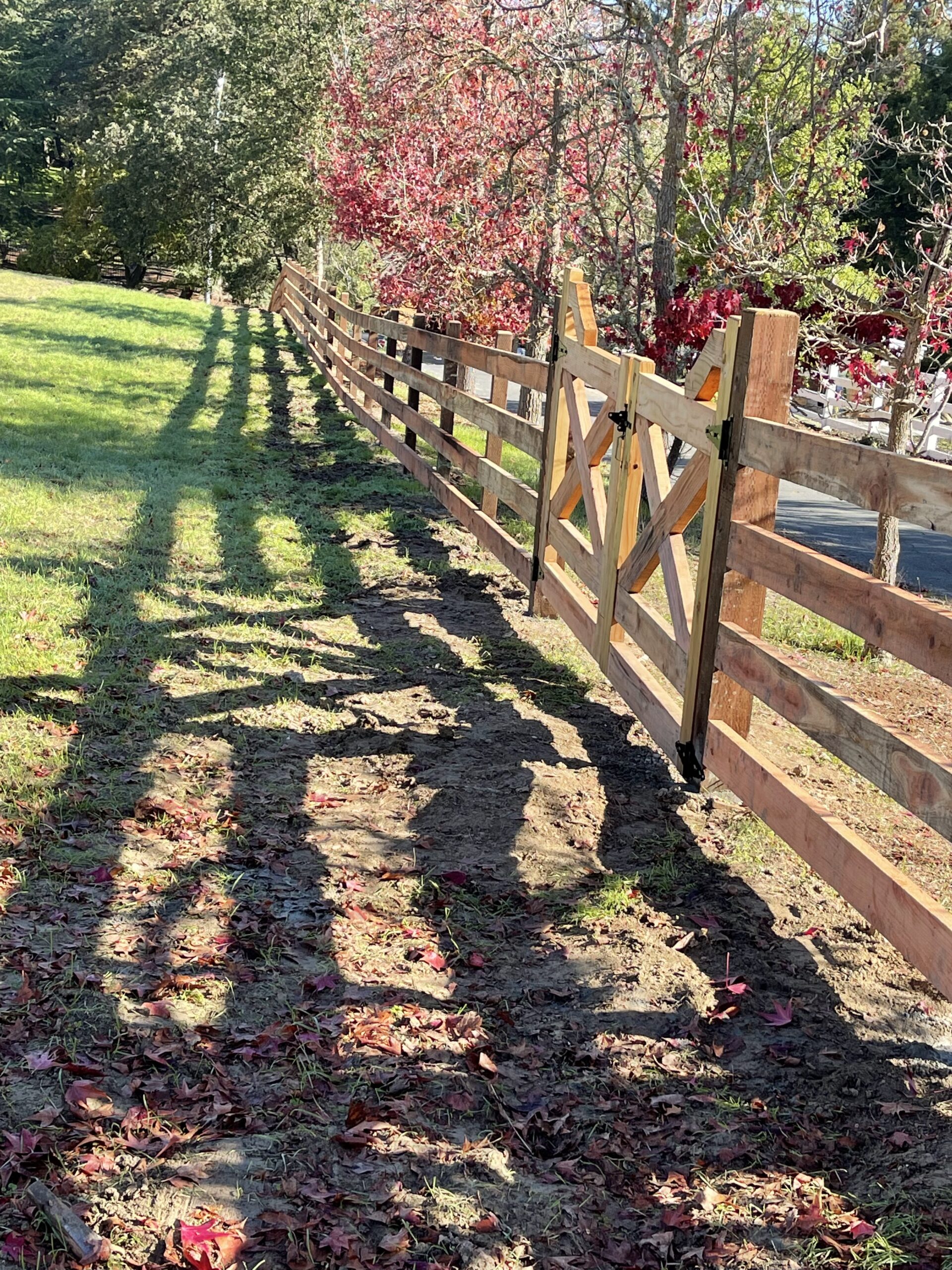 Picture of AMM Fencing installed this “ranch rail” redwood fence on a client’s property. - AMM Fencing