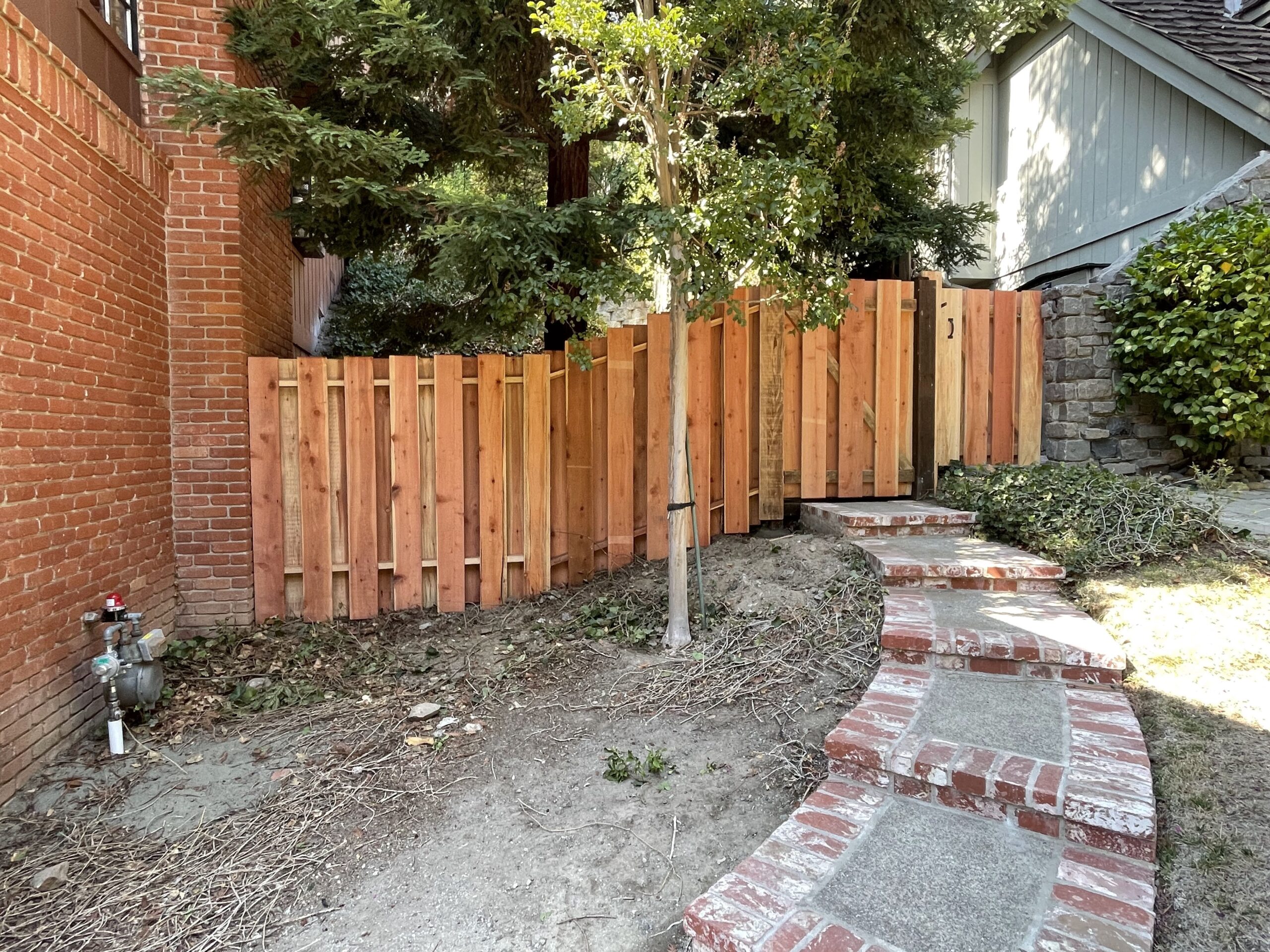 Picture of AMM Fencing uses both con common and con heart redwood boards to create shadow box fences like this one. - AMM Fencing