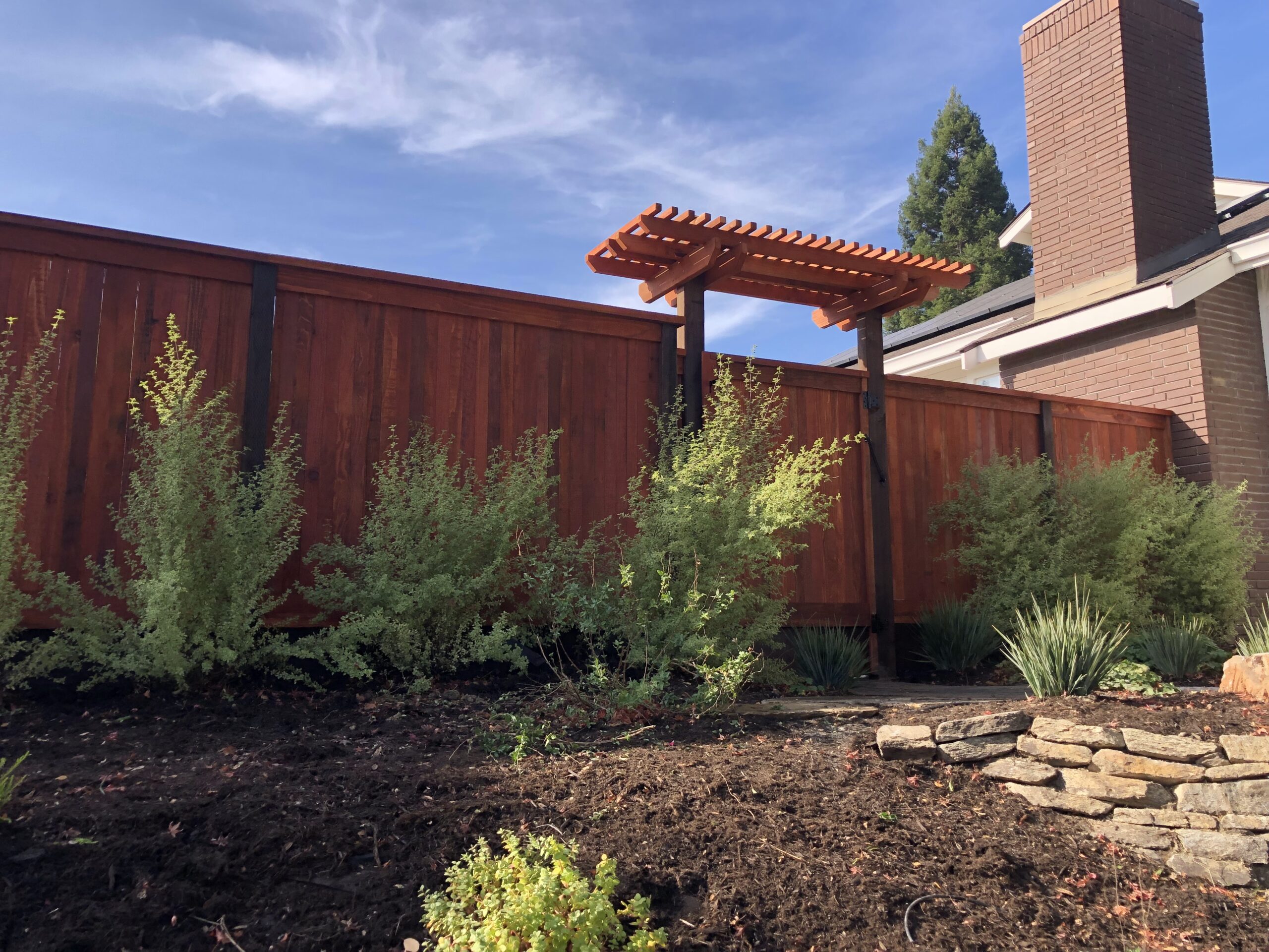 Picture of AMM Fencing installed this redwood gate with a trellis. - AMM Fencing