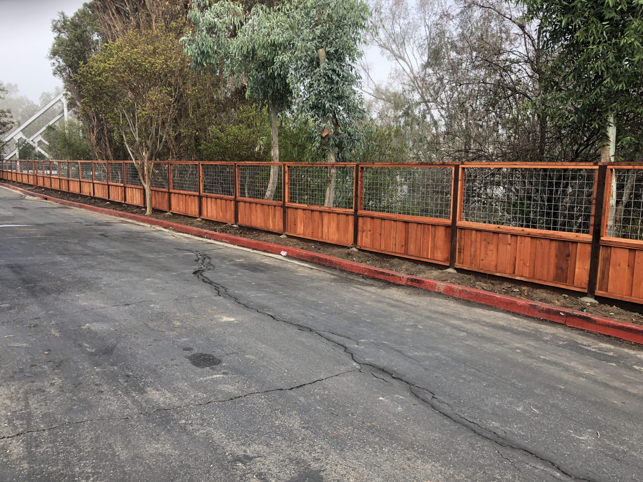 Picture of AMM Fencing installed this hybrid wire and wood fence. - AMM Fencing