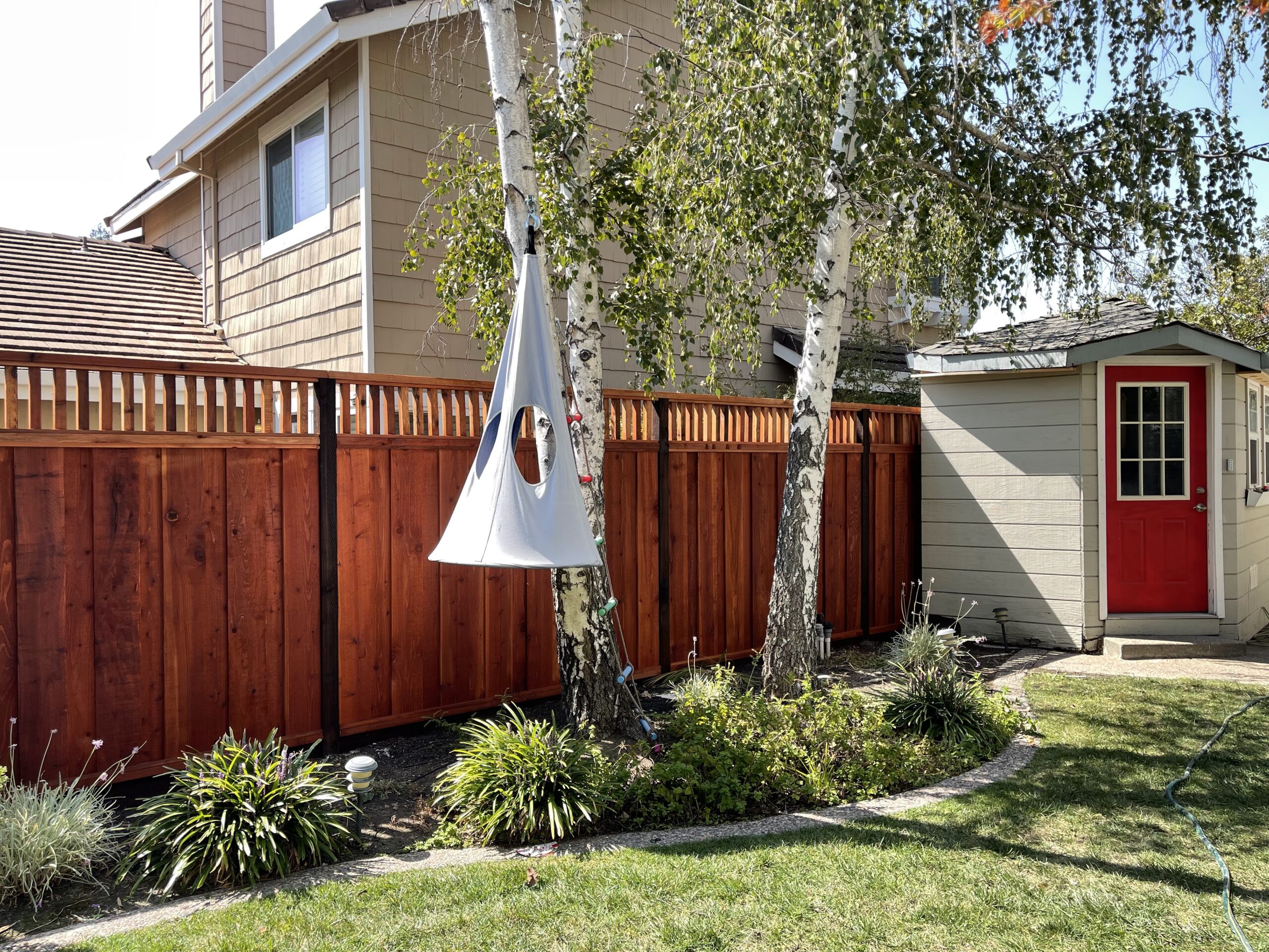 Picture of AMM Fencing installed this “piano key” lattice-style redwood fence. - AMM Fencing