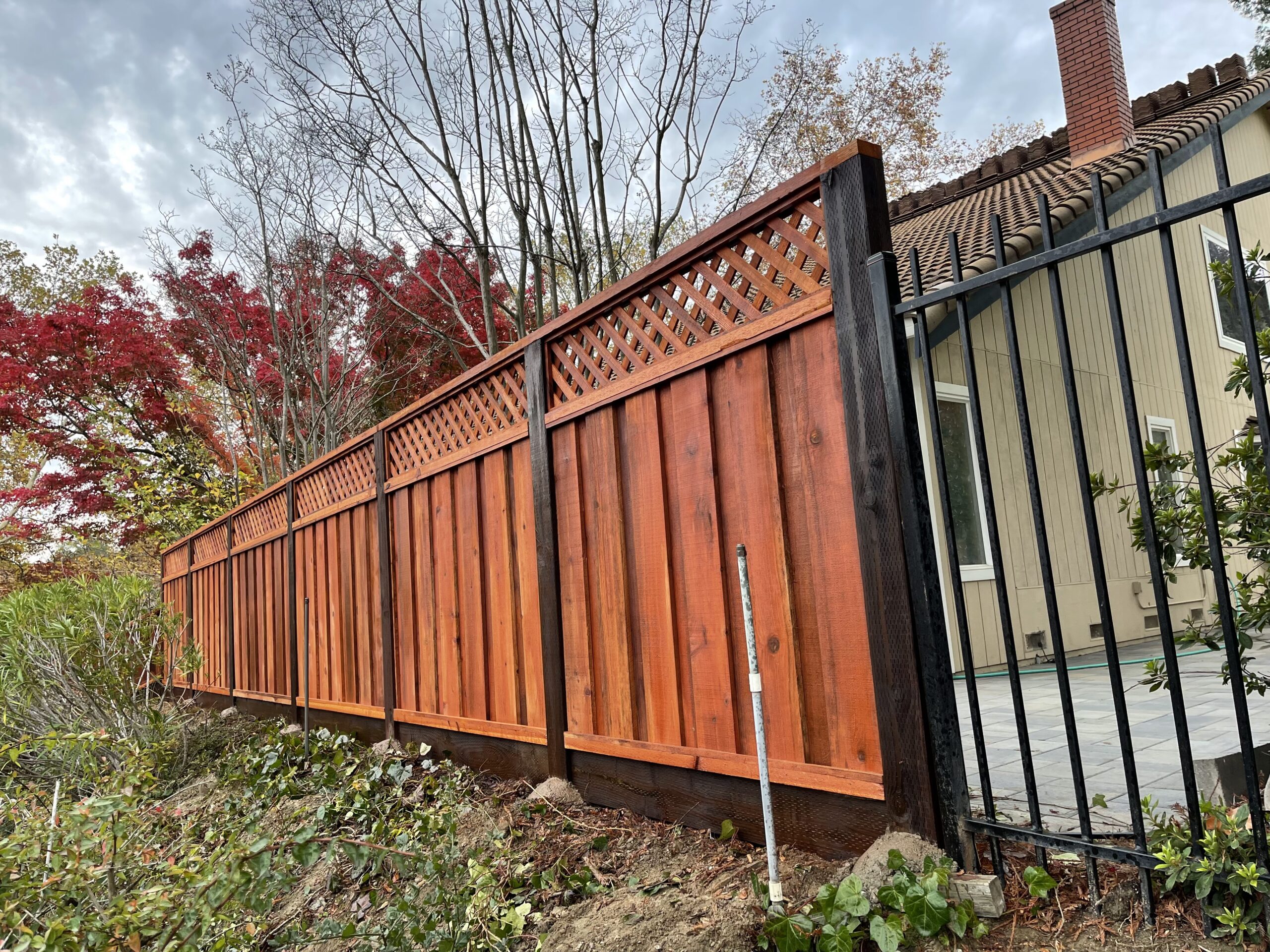 Picture of AMM Fencing installed this jumbo lattice-style redwood fence. - AMM Fencing