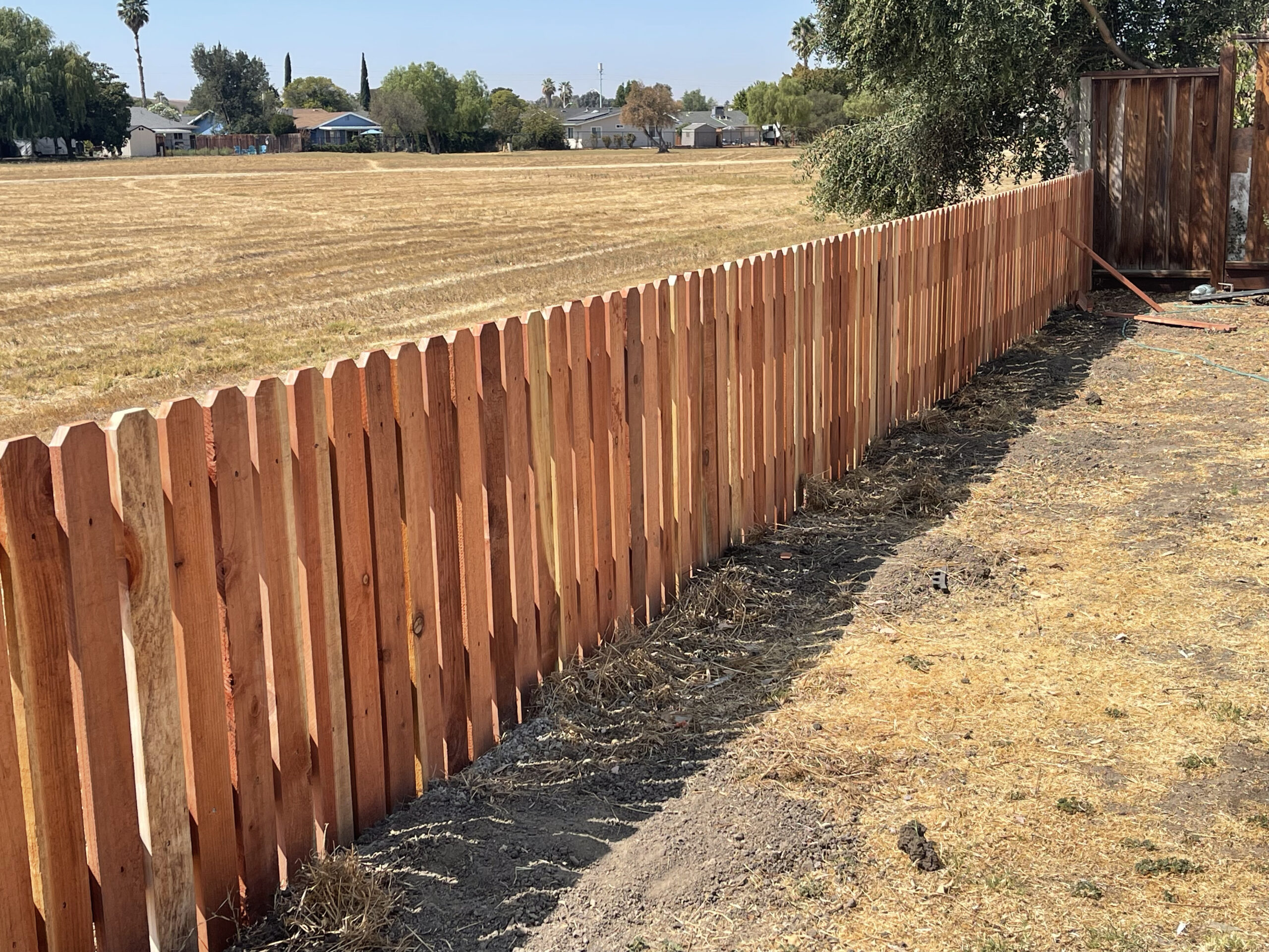 Picture of AMM Fencing installs redwood picket fences. - AMM Fencing