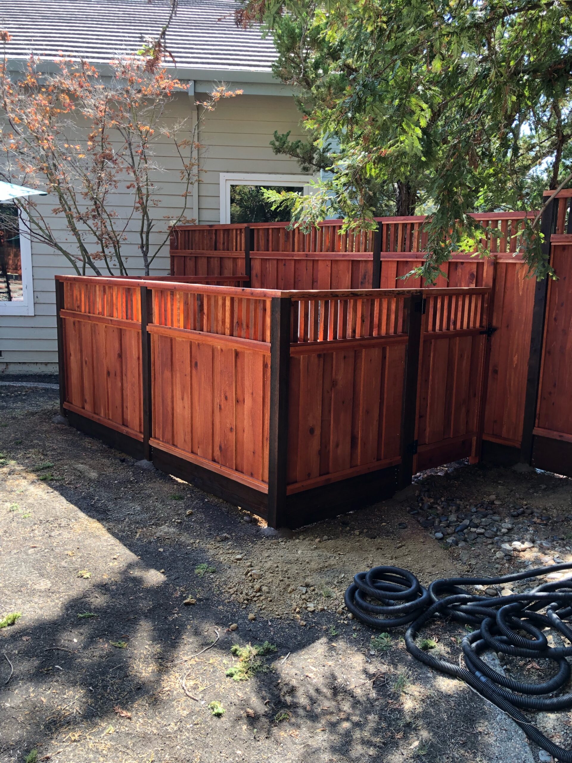 Picture of AMM Fencing installed this board-on-board redwood fence. - AMM Fencing