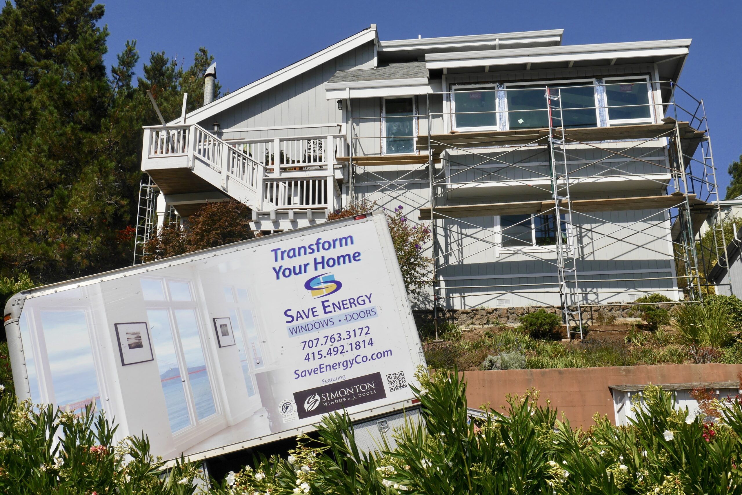 Picture of Save Energy Company installed new construction Milgard windows on this Mill Valley home. The truck hides some of the 125 stairs leading to the front door (on the very top level). - Save Energy Company