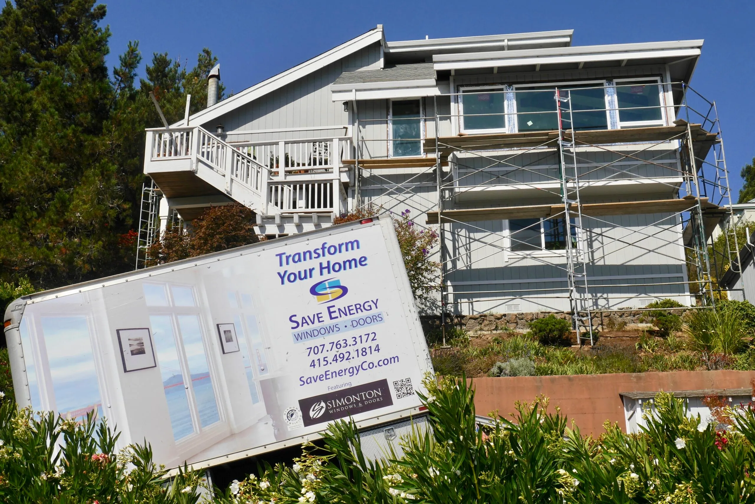 Picture of Save Energy Company installed new construction Milgard windows on this Mill Valley home. The truck hides some of the 125 stairs leading to the front door (on the very top level). - Save Energy Company