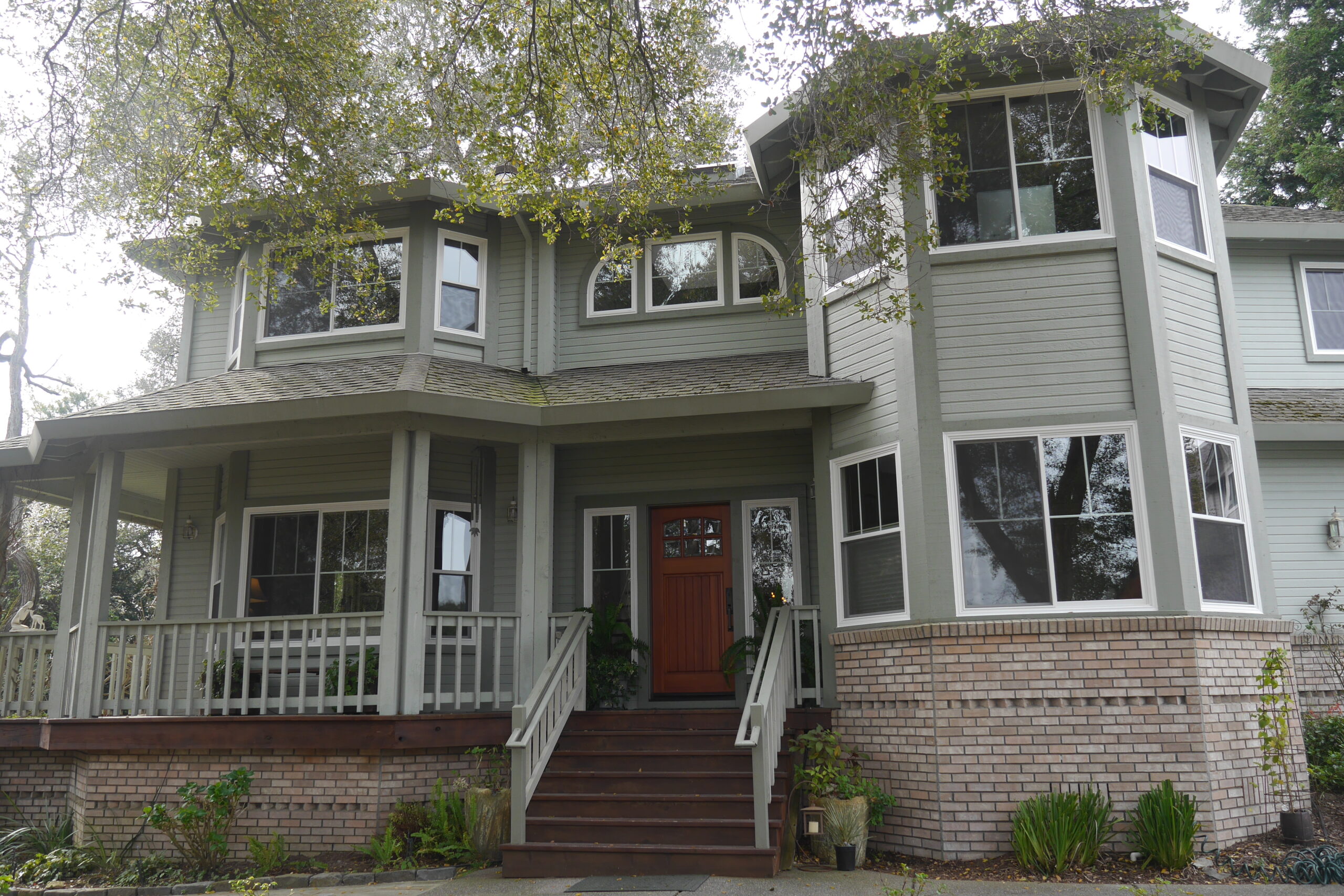 Picture of Save Energy Company installed Milgard fiberglass retrofit windows on this Petaluma farm house. The "modernized" vertical grid pattern maintains the grid theme without the business of the horizontal ba - Save Energy Company