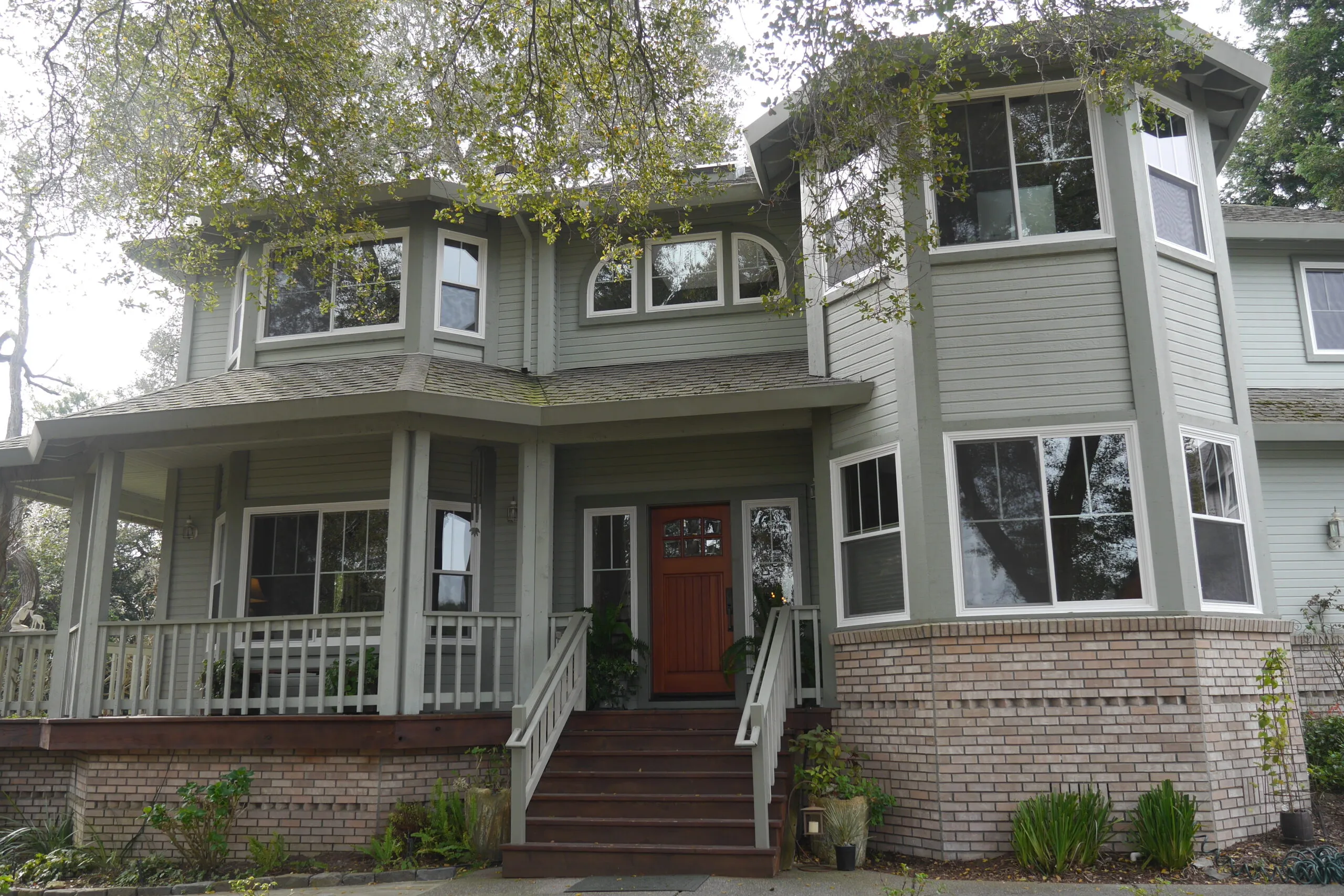 Picture of Save Energy Company installed Milgard fiberglass retrofit windows on this Petaluma farm house. The "modernized" vertical grid pattern maintains the grid theme without the business of the horizontal bars. - Save Energy Company